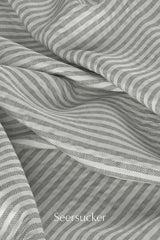 Digital fabric texture of seersucker fabric with light grey/green ticking stripe.