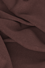 Digital fabric, dark mauve worsted wool suiting. Fabric is draped on ground with loose folds, fills entire frame.