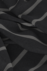 Digital fabric, dark grey worsted wool suiting with white thick stripe. Fabric is draped on ground with loose folds, fills entire frame.